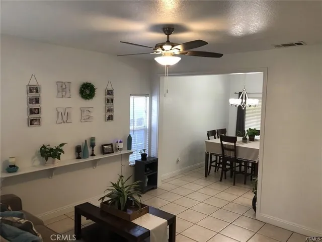 a view of a dining room with furniture and chandelier
