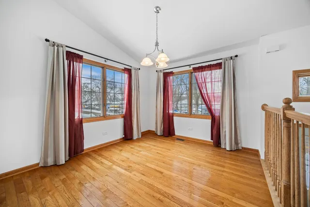 a view of a room with window wooden floor and front door