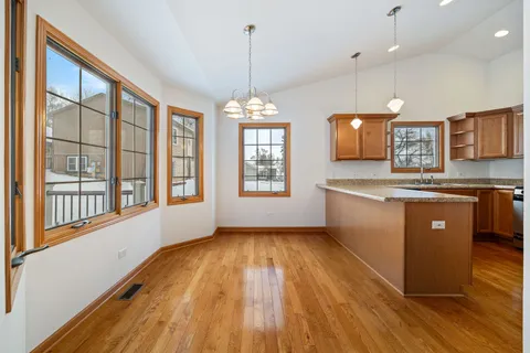 a view of kitchen with wooden floor and window