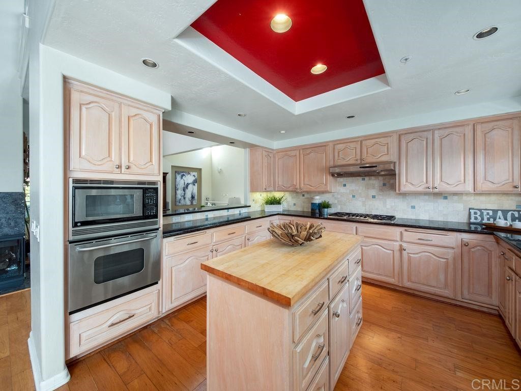 960 Valley Avenue Solana Beach, CA 92075 - Photo 14 of 51 a kitchen with stainless steel appliances granite countertop a sink and cabinets
