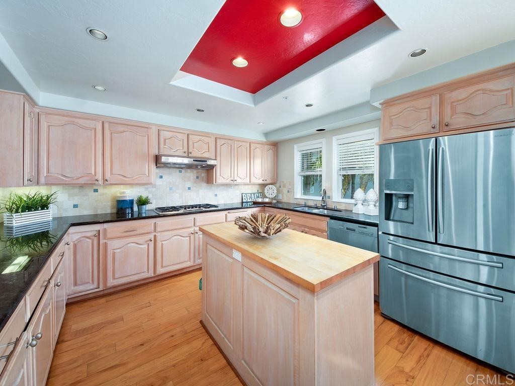 960 Valley Avenue Solana Beach, CA 92075 - Photo 15 of 51 a kitchen with stainless steel appliances granite countertop a sink stove and refrigerator