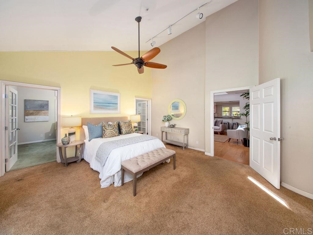 960 Valley Avenue Solana Beach, CA 92075 - Photo 21 of 51 a spacious bedroom with a bed and a chandelier