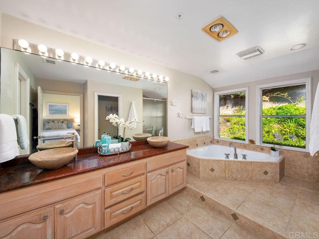 960 Valley Avenue Solana Beach, CA 92075 - Photo 22 of 51 a spacious bathroom with a granite countertop sink and a large mirror