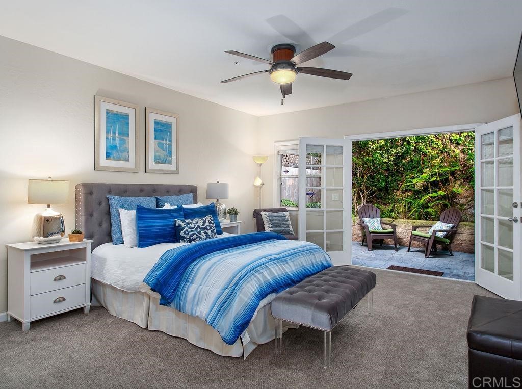 960 Valley Avenue Solana Beach, CA 92075 - Photo 37 of 51 a spacious bedroom with a large bed and a chandelier