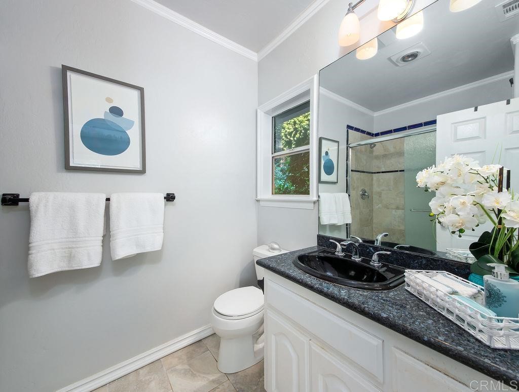 960 Valley Avenue Solana Beach, CA 92075 - Photo 38 of 51 a bathroom with a granite countertop sink and a mirror