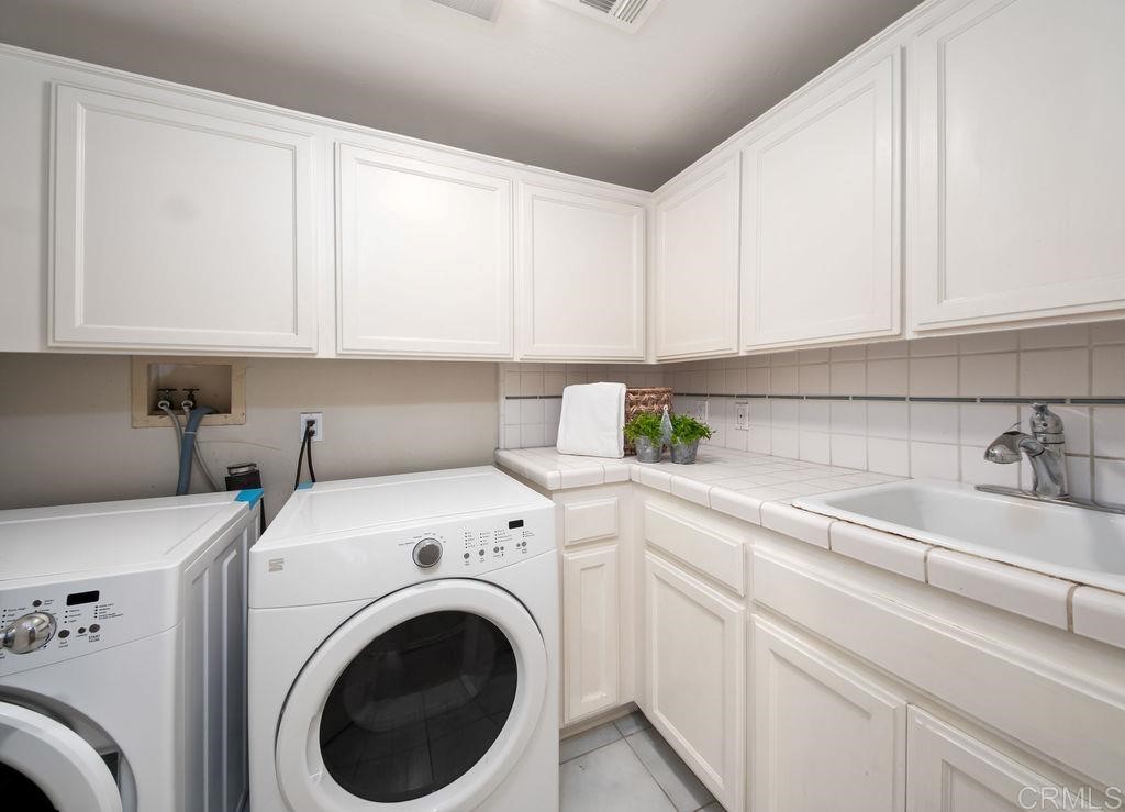 960 Valley Avenue Solana Beach, CA 92075 - Photo 40 of 51 a utility room with sink dryer and washer