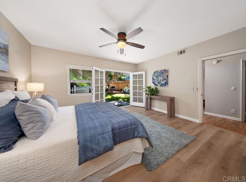 960 Valley Avenue Solana Beach, CA 92075 - Photo 41 of 51 a bedroom with a large bed and a chandelier