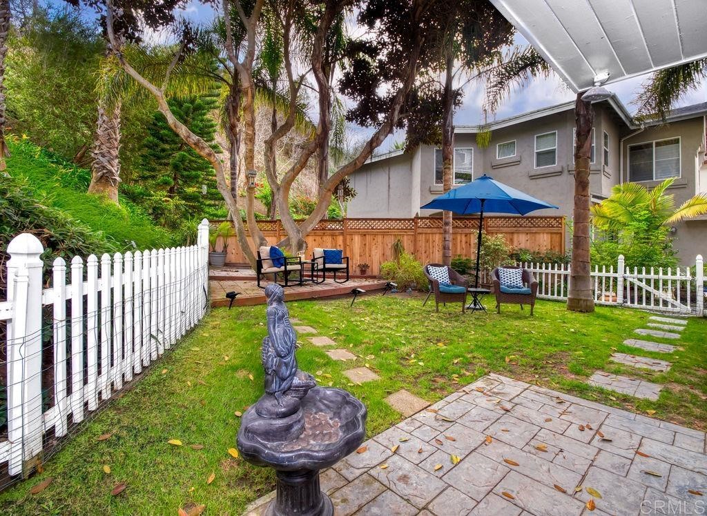 960 Valley Avenue Solana Beach, CA 92075 - Photo 46 of 51 a view of a patio with a table and chairs under an umbrella