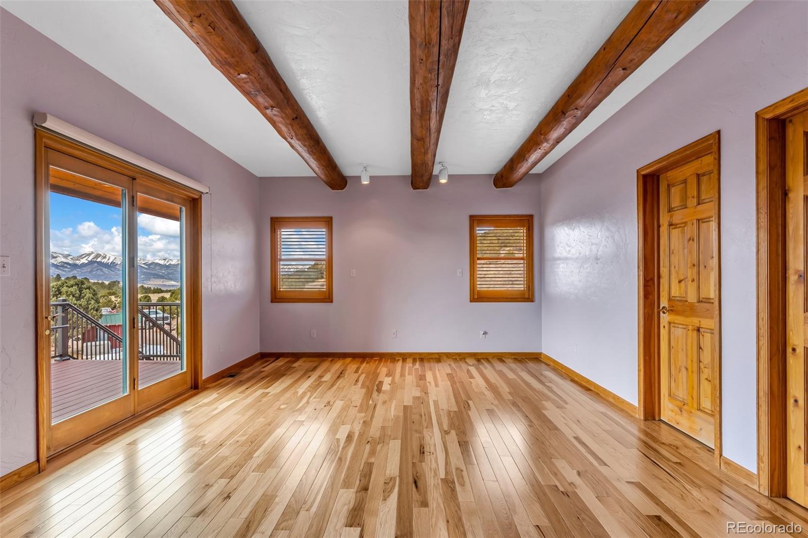 4230 Timber Ridge Road Westcliffe, CO 81252 - Photo 15 of 37 a view of an empty room with wooden floor and windows