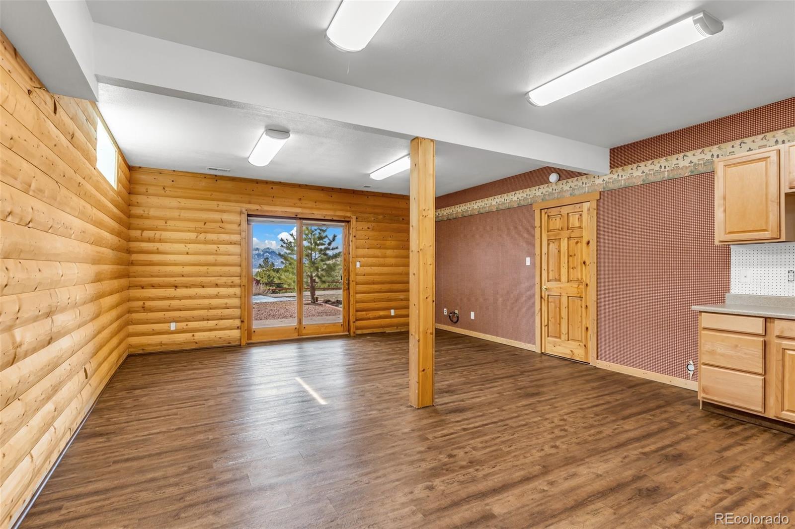 4230 Timber Ridge Road Westcliffe, CO 81252 - Photo 19 of 37 a view of an empty room with wooden floor and a window