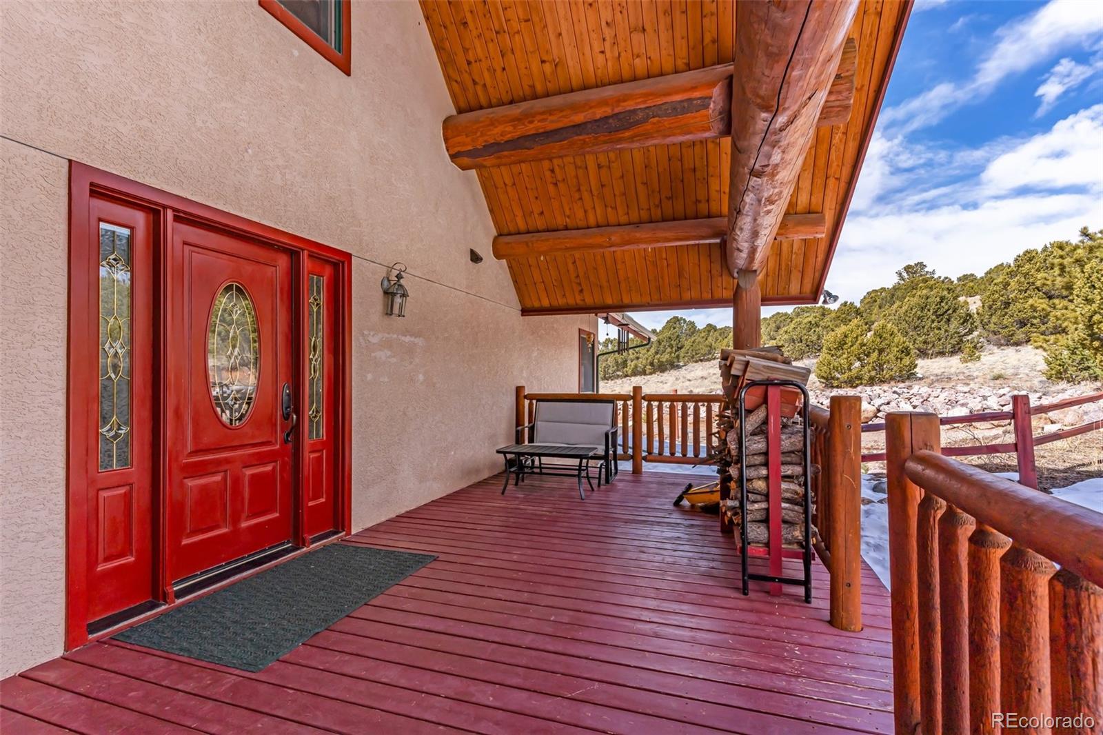 4230 Timber Ridge Road Westcliffe, CO 81252 - Photo 3 of 37 a view of a balcony with chairs and wooden floor
