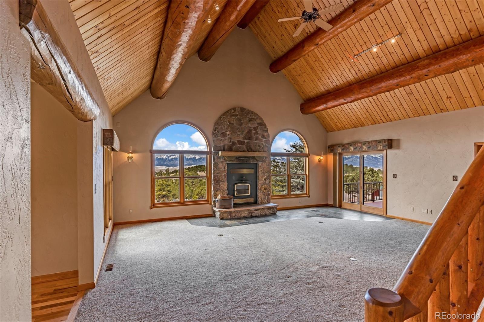 4230 Timber Ridge Road Westcliffe, CO 81252 - Photo 5 of 37 a view of an empty room with a fireplace and a window
