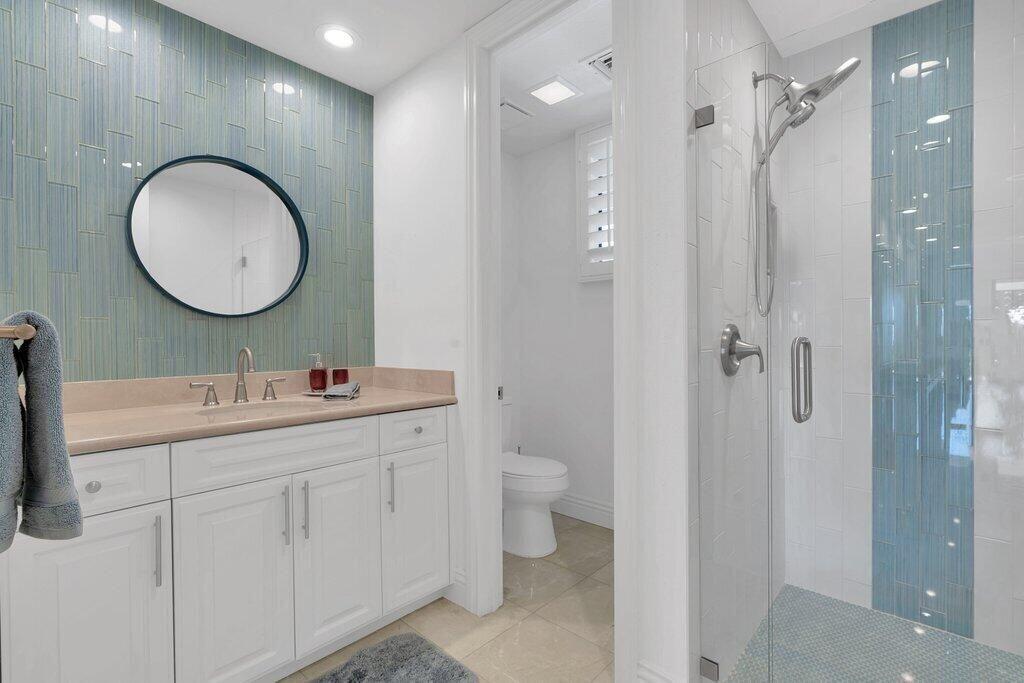 6 Barnard Court Rancho Mirage, CA 92270 - Photo 11 of 50 a bathroom with a toilet a sink a mirror and vanity