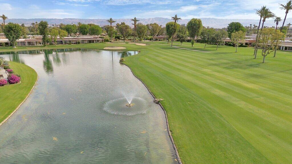 6 Barnard Court Rancho Mirage, CA 92270 - Photo 22 of 50 a view of a lake with a yard and large trees