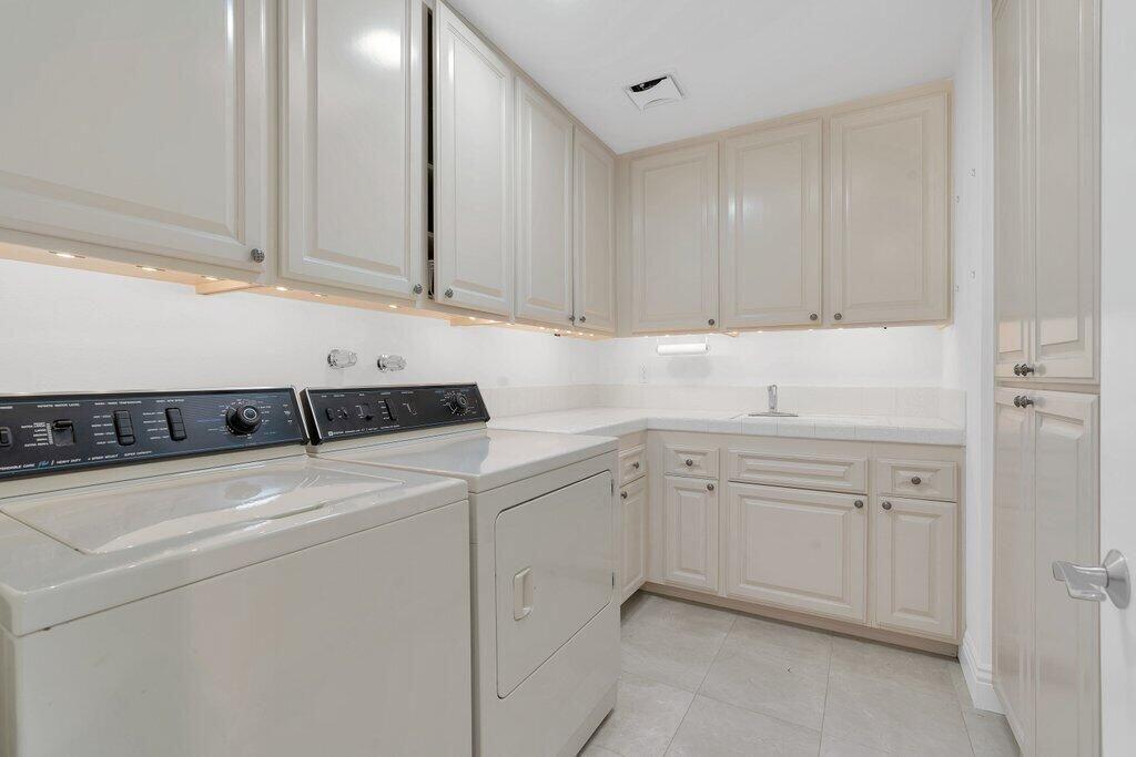 6 Barnard Court Rancho Mirage, CA 92270 - Photo 28 of 50 a utility room with cabinets washer and dryer