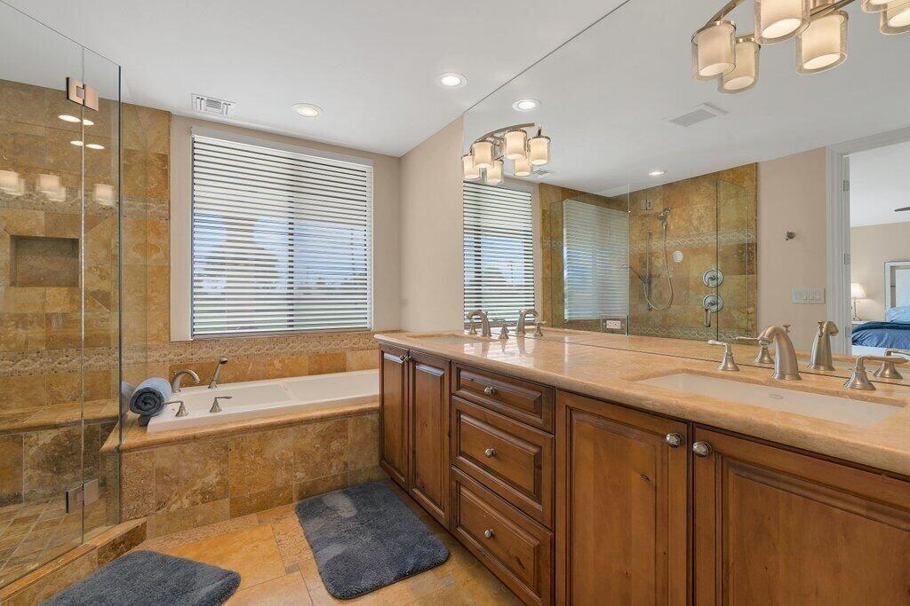 6 Barnard Court Rancho Mirage, CA 92270 - Photo 30 of 50 a spacious bathroom with a double vanity sink large mirror and a bathtub