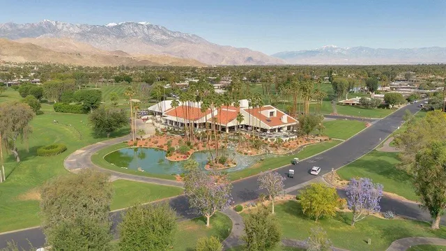 an aerial view of a house with a yard and lake view