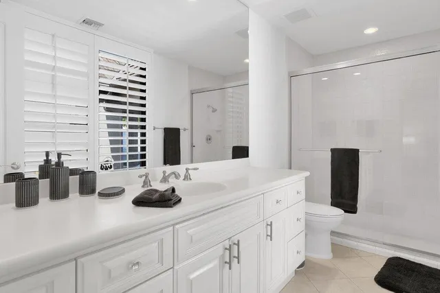 a spacious bedroom with a bed and a large window