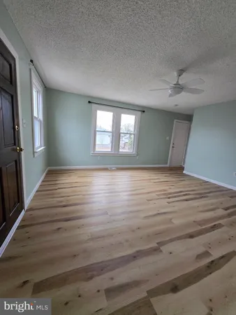 a view of hallway with wooden floor