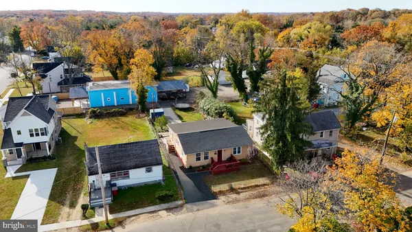 a view of a house with swimming pool next to a yard
