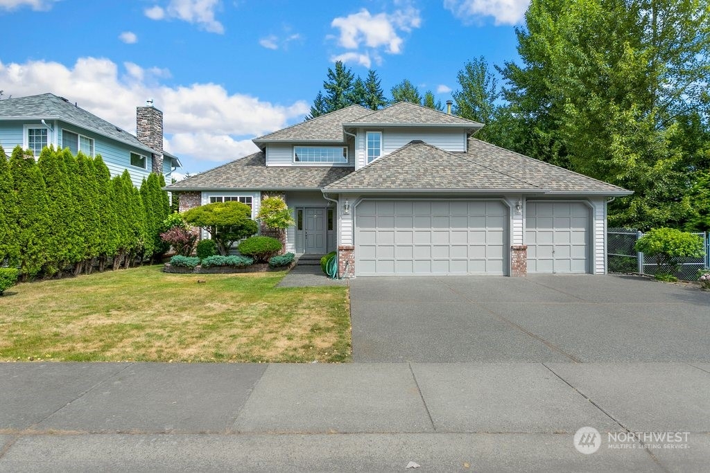 1315 231st Street Southeast Bothell, WA 98021 - Photo 1 of 34 a front view of a house with a garden