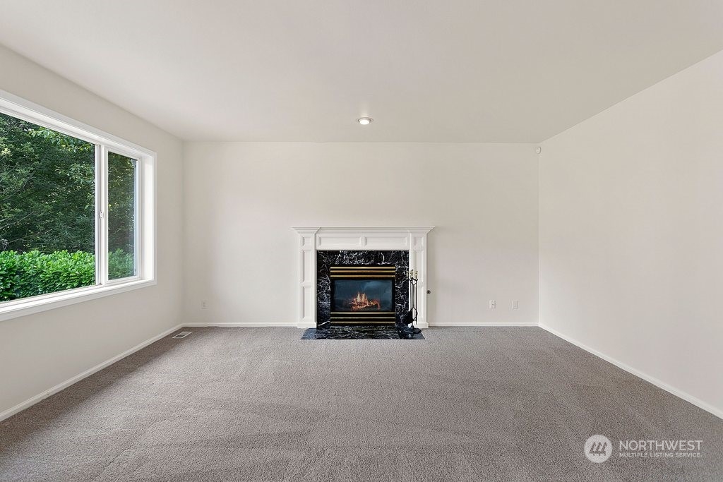1315 231st Street Southeast Bothell, WA 98021 - Photo 15 of 34 an empty room with windows and fireplace