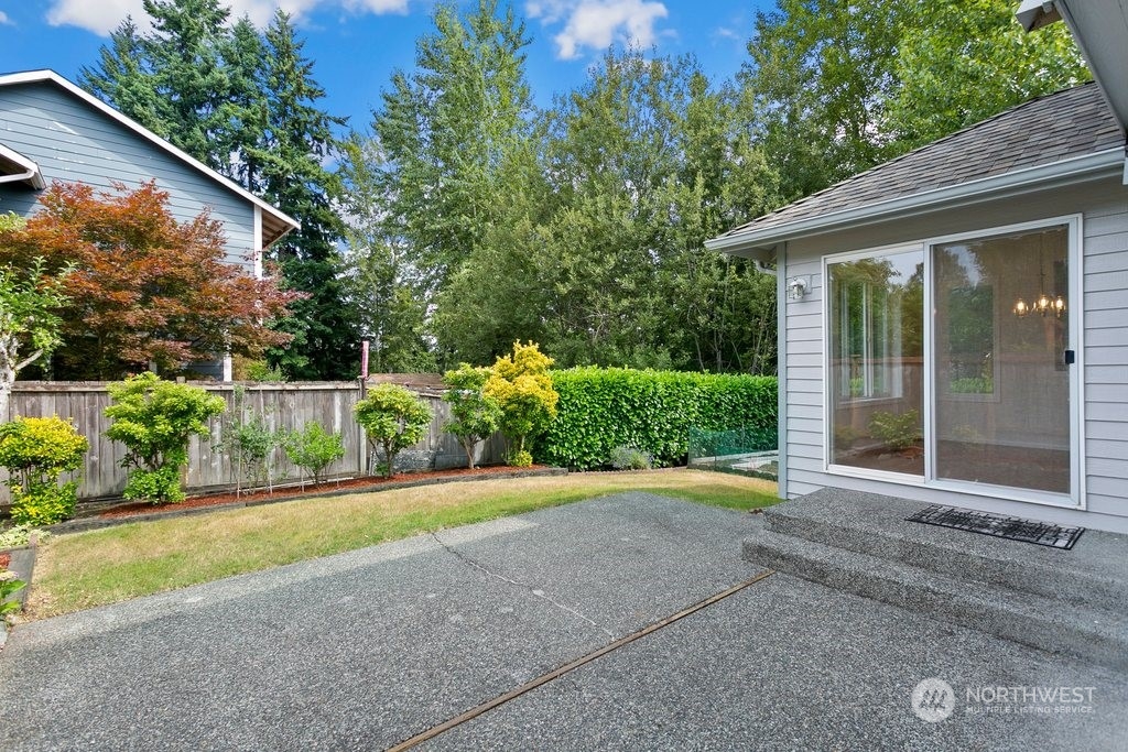 1315 231st Street Southeast Bothell, WA 98021 - Photo 30 of 34 a view of backyard with potted plants and floor to ceiling window