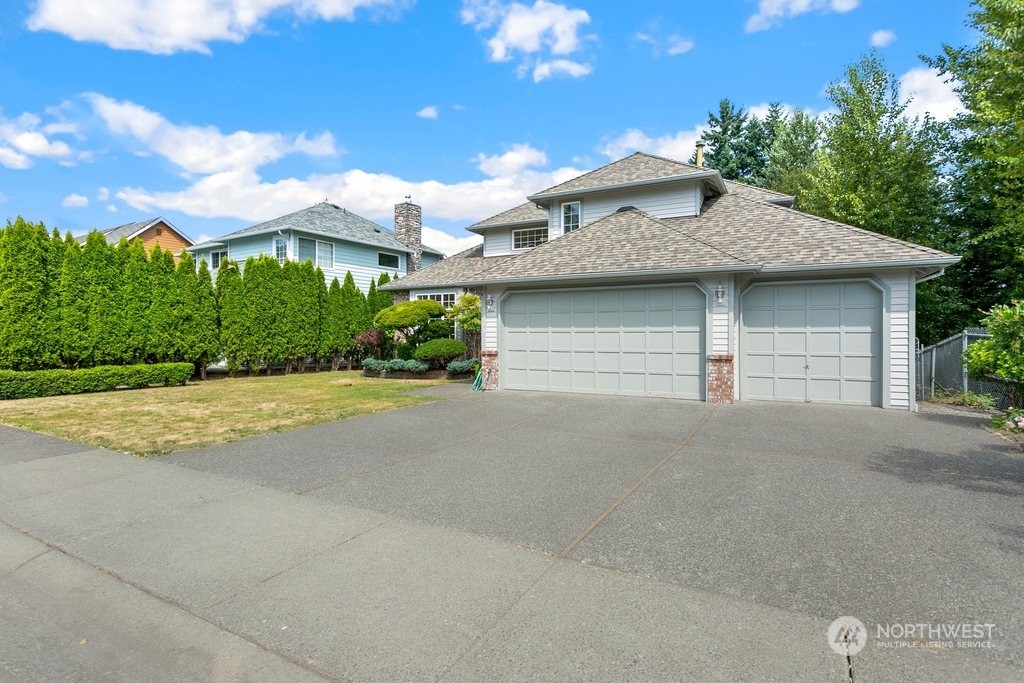 1315 231st Street Southeast Bothell, WA 98021 - Photo 3 of 34 a view of a house with a yard and garage