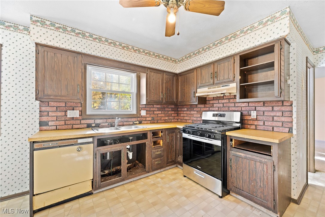 3550 Boston Road Brunswick, OH 44212 - Photo 7 of 37 Kitchen featuring wallpapered walls, light floors, gas range, open shelves, and wood counters