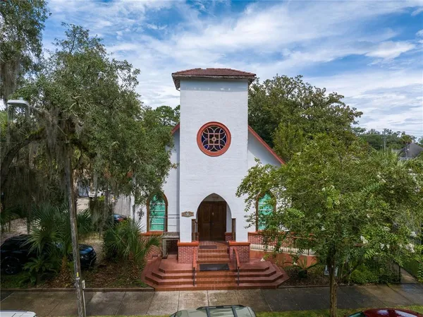 a view of a wooden house with a swimming pool and a yard