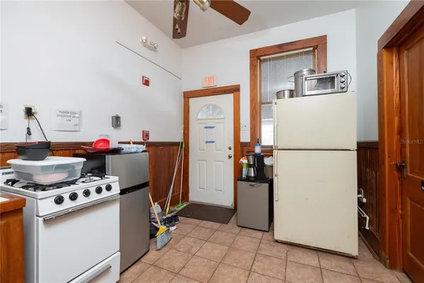 a bedroom with a bed ceiling fan and a window
