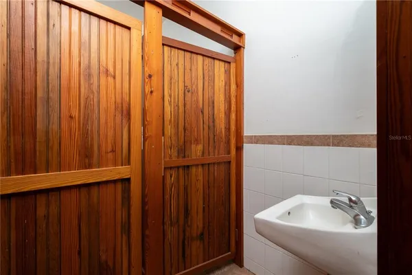 a view of a house with wooden fence and a trees