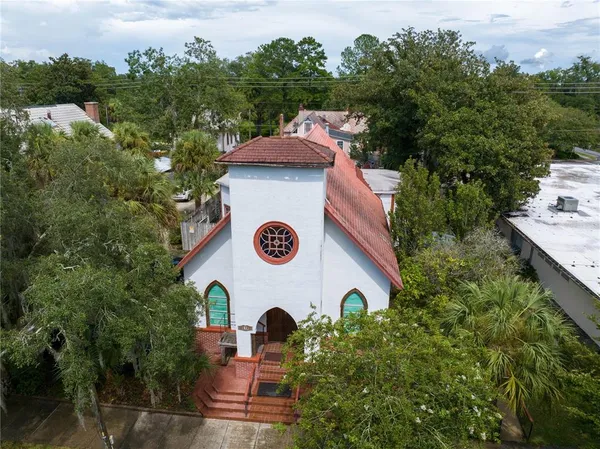 an aerial view of a house with yard and outdoor seating