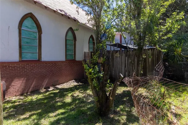 a room with lots of wooden furniture and a chandelier