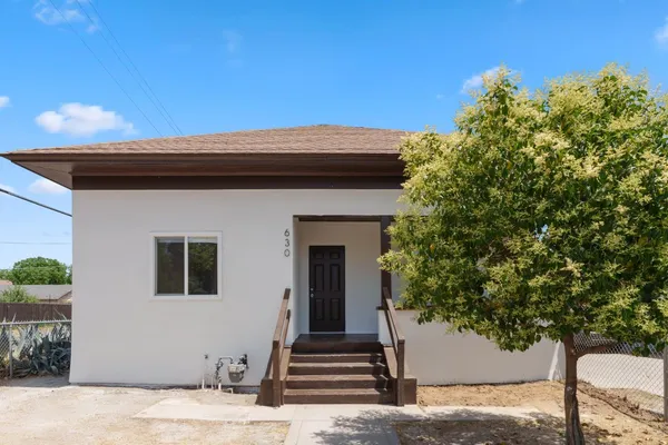 a front view of a house with trees