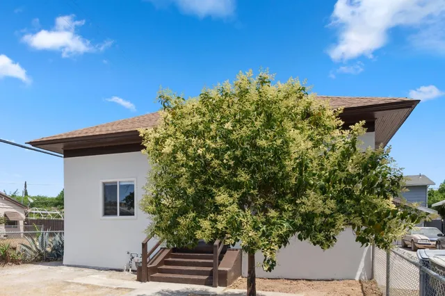 a view of a house with a tree