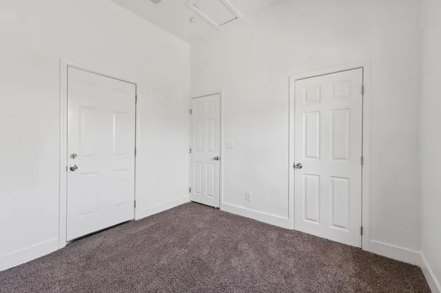 a view of backyard with small cabin and wooden fencing