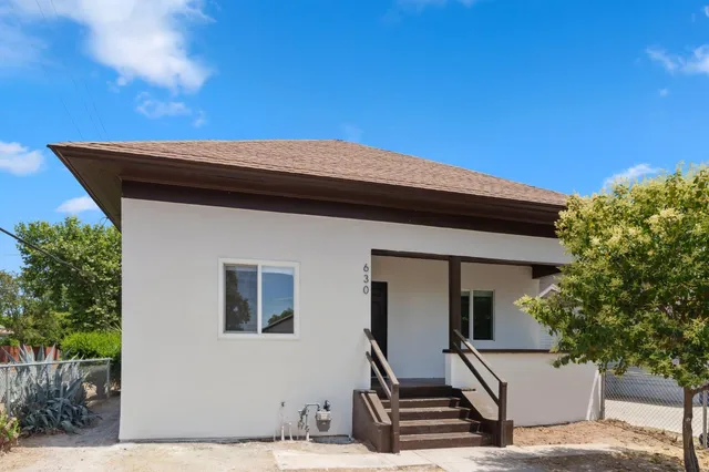 a front view of a house with a garden