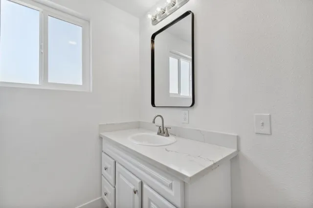 a bathroom with a sink and a mirror