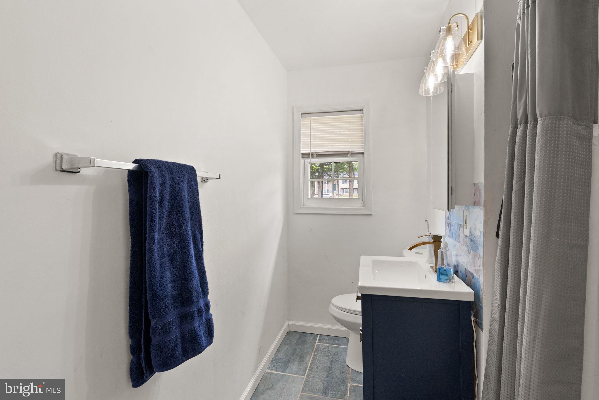 14501 Livingston Road Accokeek, MD 20607 - Photo 20 of 32 a bathroom with a sink and mirror with toilet