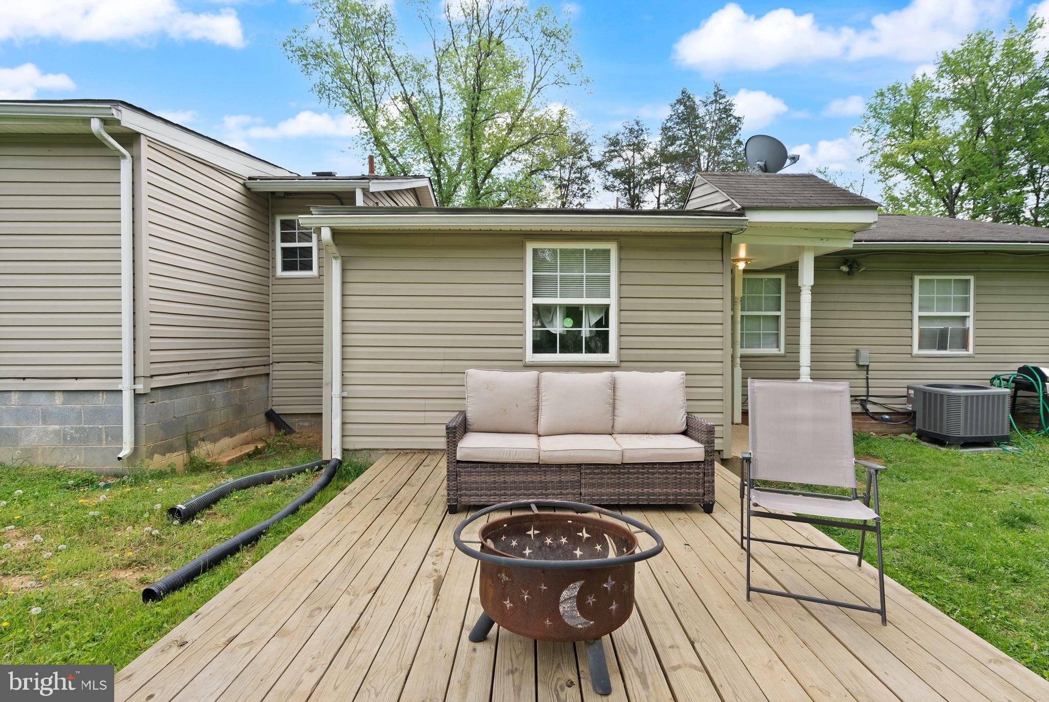 14501 Livingston Road Accokeek, MD 20607 - Photo 26 of 32 a view of a patio with table and chairs with wooden floor and fence