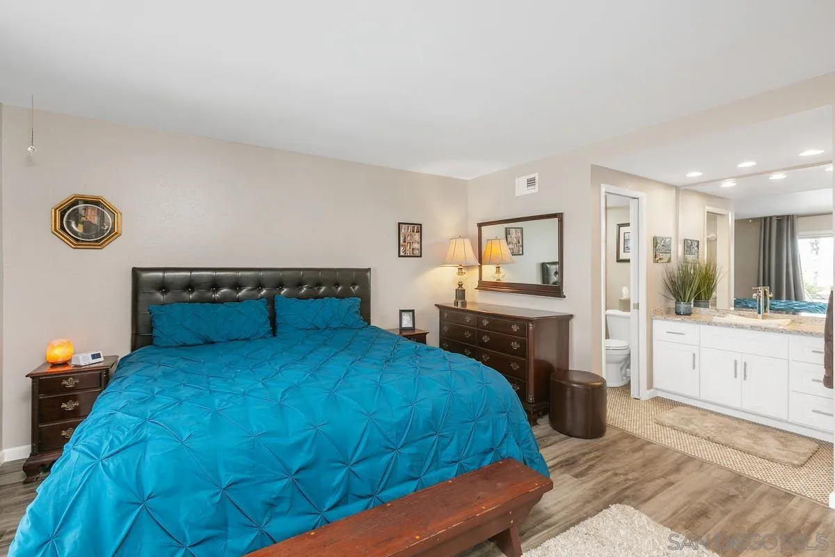 10934 Avenida Roberta Spring Valley, CA 91978 - Photo 16 of 30 a bedroom with a bed and a chandelier