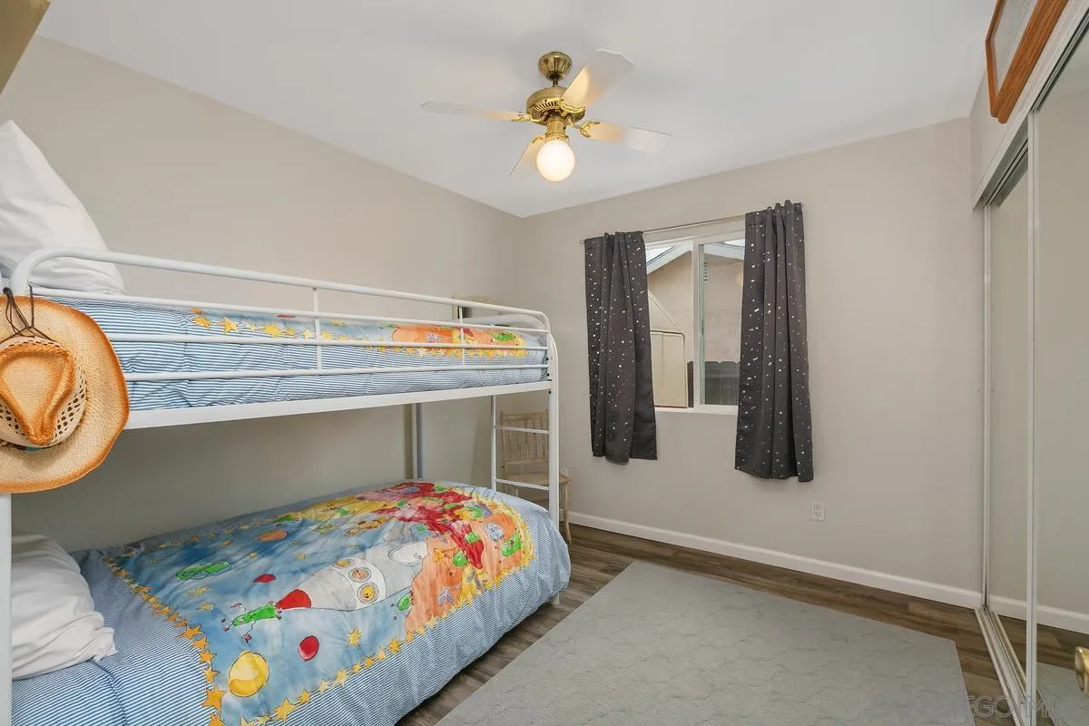 10934 Avenida Roberta Spring Valley, CA 91978 - Photo 18 of 30 a bedroom with a bed and a chandelier