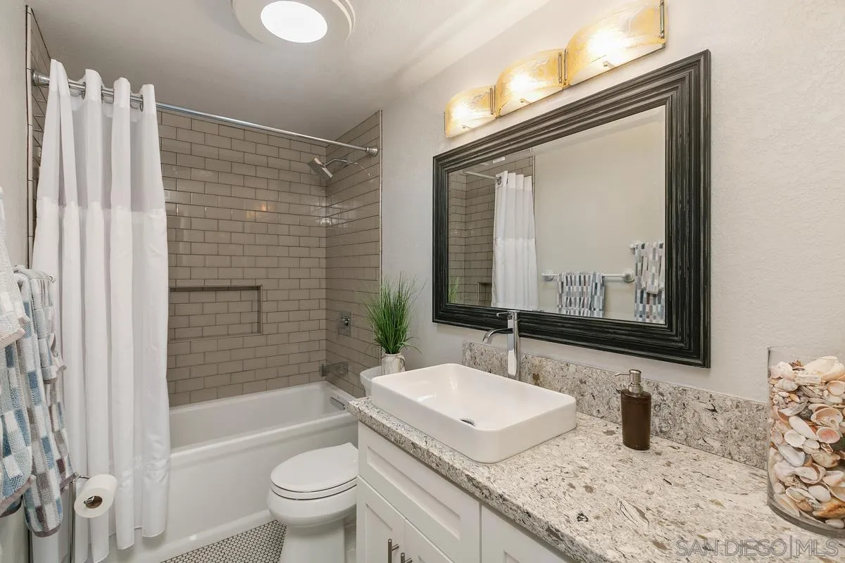 10934 Avenida Roberta Spring Valley, CA 91978 - Photo 19 of 30 a bathroom with a granite countertop sink toilet and shower
