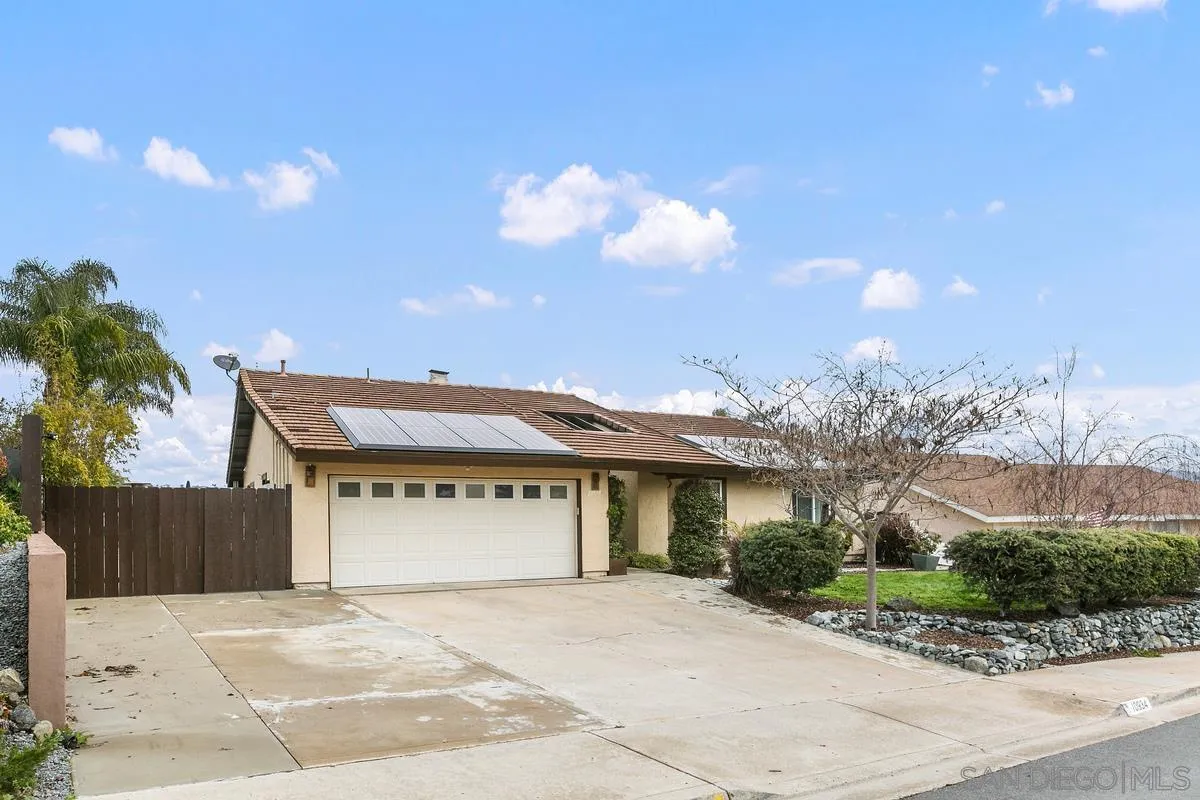 10934 Avenida Roberta Spring Valley, CA 91978 - Photo 3 of 30 a front view of a house with a yard and garage