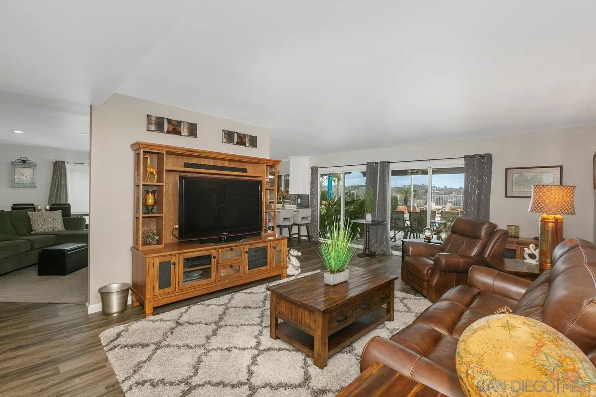 10934 Avenida Roberta Spring Valley, CA 91978 - Photo 6 of 30 a living room with furniture and a flat screen tv