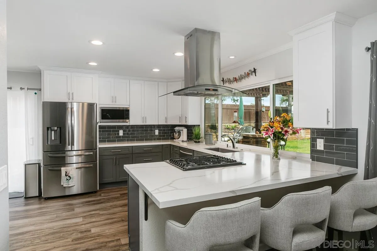 10934 Avenida Roberta Spring Valley, CA 91978 - Photo 9 of 30 a kitchen with stainless steel appliances granite countertop a sink a stove and a refrigerator