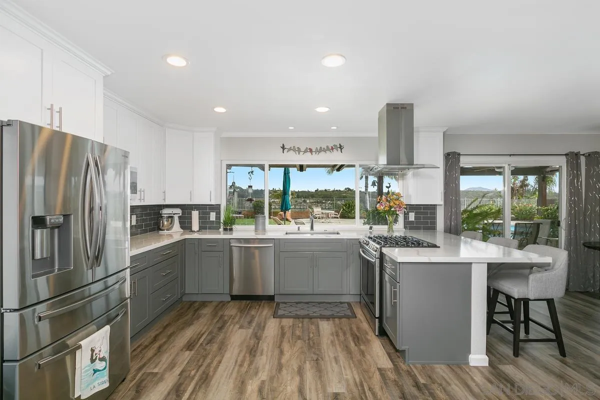 10934 Avenida Roberta Spring Valley, CA 91978 - Photo 10 of 30 a kitchen with sink cabinets and stainless steel appliances