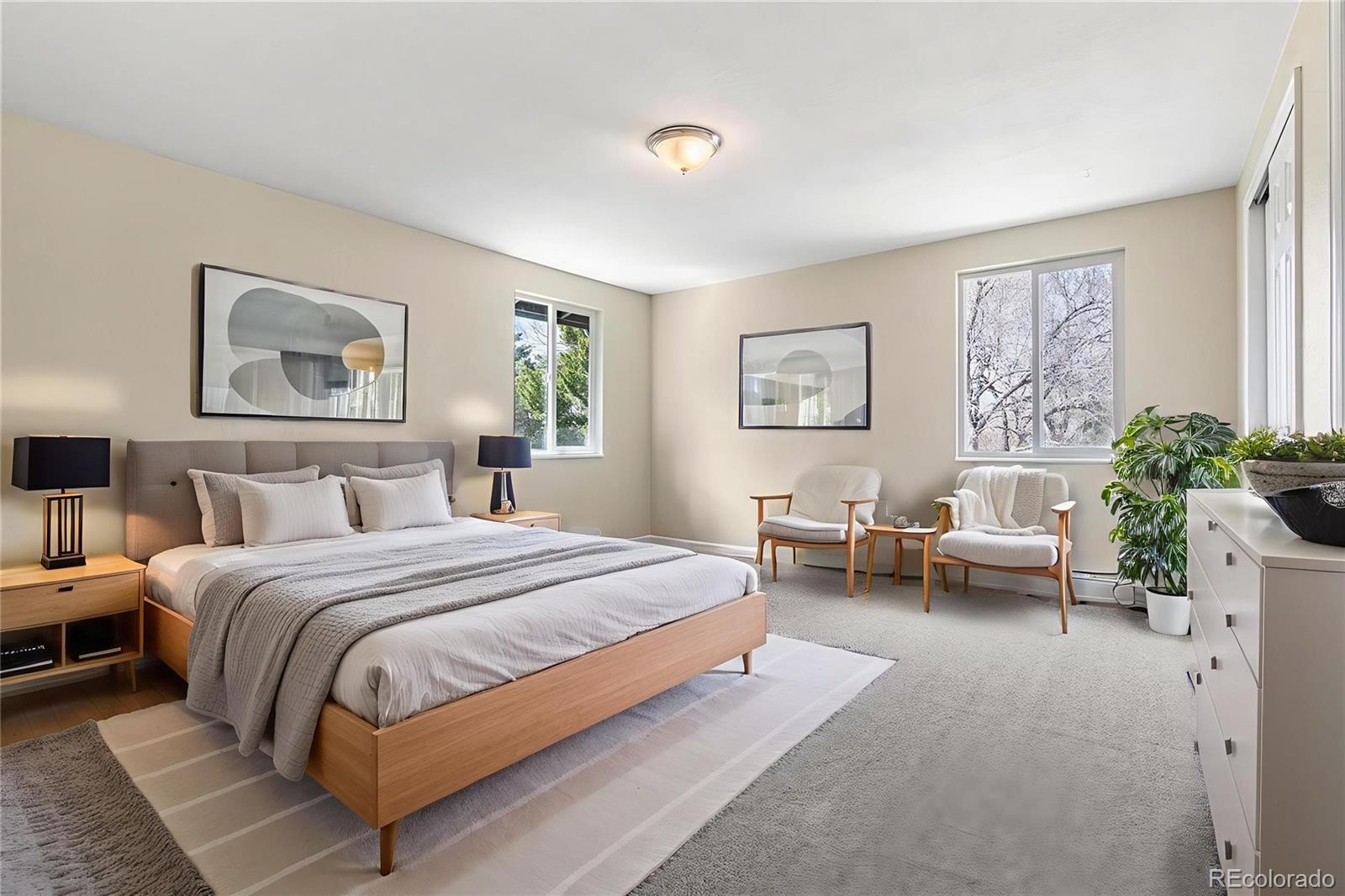 3301 South Magnolia Street Denver, CO 80224 - Photo 14 of 33 a spacious bedroom with a bed and a couch