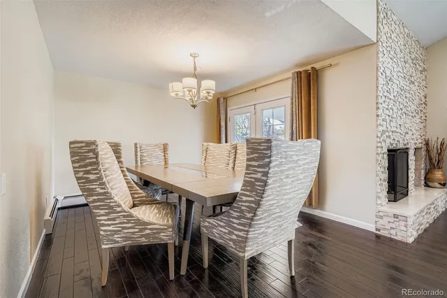 a view of a dining room with furniture wooden floor and chandelier